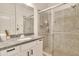 Bathroom showcasing a granite countertop vanity and glass-enclosed shower with tile surround at 5450 E Deer Valley Dr # 1004, Phoenix, AZ 85054