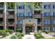 Charming building entrance featuring stone accents, well-maintained landscaping, and covered access at 5450 E Deer Valley Dr # 1004, Phoenix, AZ 85054