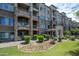 Beautiful exterior showcases stone accents, multiple balconies, and professionally landscaped grounds at 5450 E Deer Valley Dr # 1004, Phoenix, AZ 85054