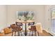 Bright dining area with a round table, upholstered chairs, and a window view at 5450 E Deer Valley Dr # 1004, Phoenix, AZ 85054