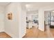 Inviting entryway with hardwood floors, opening to a modern kitchen and living area at 5450 E Deer Valley Dr # 1004, Phoenix, AZ 85054