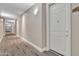 Bright hallway featuring carpet flooring, modern lighting fixtures, and neutral wall paint at 5450 E Deer Valley Dr # 1004, Phoenix, AZ 85054