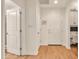Clean hallway with wood floors, crisp white trim and doors, and recessed lighting at 5450 E Deer Valley Dr # 1004, Phoenix, AZ 85054