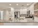 Bright kitchen showcases white cabinets, stainless steel appliances, and granite island counter at 5450 E Deer Valley Dr # 1004, Phoenix, AZ 85054