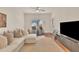 Bright living room featuring a plush white sectional, modern ceiling fan and a stylish bar table with seating at 5450 E Deer Valley Dr # 1004, Phoenix, AZ 85054