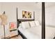 Bedroom featuring a four-poster bed with white linens and stylish bedside decor at 5450 E Deer Valley Dr # 1004, Phoenix, AZ 85054