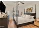 Bedroom with a four-poster bed, dark wood furniture, and natural light from the window at 5450 E Deer Valley Dr # 1004, Phoenix, AZ 85054