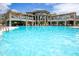 Expansive community pool with plenty of lounge seating and a beautifully designed clubhouse in the background at 5450 E Deer Valley Dr # 1004, Phoenix, AZ 85054