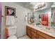 Bathroom featuring double sinks, wood cabinets and updated fixtures at 5710 E Anderson Dr, Scottsdale, AZ 85254