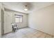 Empty bedroom with neutral tile floors, a small window and standard ceiling light at 5710 E Anderson Dr, Scottsdale, AZ 85254