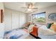 Bedroom with a large window offering views of landscaping and a ceiling fan at 5710 E Anderson Dr, Scottsdale, AZ 85254