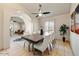 Dining room featuring tile floors, a modern table with seating for six, and a stylish ceiling fan at 5710 E Anderson Dr, Scottsdale, AZ 85254