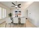 Dining room featuring a modern table, comfortable seating for six, neutral walls, and a ceiling fan at 5710 E Anderson Dr, Scottsdale, AZ 85254