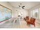 Home office with tile floors, a modern desk and chairs, natural light, and a ceiling fan at 5710 E Anderson Dr, Scottsdale, AZ 85254