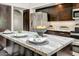 Elegant kitchen island with marble countertops and dark wood cabinetry, perfect for entertaining at 5710 E Anderson Dr, Scottsdale, AZ 85254