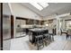 Stylish kitchen with dark cabinets, stainless steel appliances, a center island, and a skylight at 5710 E Anderson Dr, Scottsdale, AZ 85254