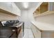 Spacious laundry room with side by side washer, dryer and shelving for storage at 5710 E Anderson Dr, Scottsdale, AZ 85254