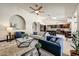 Inviting living area with an arched niche and an open floor plan to the kitchen and dining space at 5710 E Anderson Dr, Scottsdale, AZ 85254