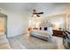 Spacious main bedroom with a ceiling fan, neutral colors, and easy access to the ensuite bathroom at 5710 E Anderson Dr, Scottsdale, AZ 85254
