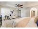 Bright main bedroom features a ceiling fan, comfortable seating, and ensuite bathroom access at 5710 E Anderson Dr, Scottsdale, AZ 85254