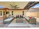 Inviting covered patio with stylish seating, ceiling fan, and neutral color scheme on a patterned tile floor at 5710 E Anderson Dr, Scottsdale, AZ 85254