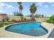 Backyard pool surrounded by mature landscaping and a stone privacy fence at 5710 E Anderson Dr, Scottsdale, AZ 85254