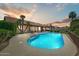 Backyard pool illuminated by the sunset, surrounded by lush landscaping, and a comfortable patio area at 5710 E Anderson Dr, Scottsdale, AZ 85254