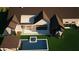 Stunning overhead view of a private backyard with a pool, spa, covered patio, and green lawn at 6234 S Brett Ct, Gilbert, AZ 85298
