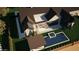 Serene aerial view of a home with a sparkling pool, outdoor seating area, and lush landscaping at 6234 S Brett Ct, Gilbert, AZ 85298