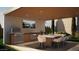 An outdoor kitchen featuring a grill, sink, tv, dining table, and counterspace at 6234 S Brett Ct, Gilbert, AZ 85298