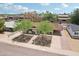Aerial view of a well-maintained home with beautiful landscaping, and a covered carport at 7049 E Latham St, Scottsdale, AZ 85257