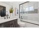 A stylish bathroom featuring modern fixtures, a shower-tub combo, and elegant finishes at 7049 E Latham St, Scottsdale, AZ 85257