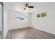 A bright bedroom with wood flooring, white walls, and windows with lovely outdoor views at 7049 E Latham St, Scottsdale, AZ 85257