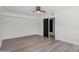 A bright bedroom with wood flooring, white walls, and access to another room at 7049 E Latham St, Scottsdale, AZ 85257