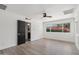 A bright bedroom with wood flooring, white walls, ceiling fan and access to a bathroom at 7049 E Latham St, Scottsdale, AZ 85257