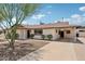 This home features low-maintenance landscaping, covered parking, and a walkway at 7049 E Latham St, Scottsdale, AZ 85257