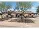 Classic single-story home featuring desert landscaping, a walkway, and covered parking area at 7049 E Latham St, Scottsdale, AZ 85257