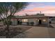 Charming single-story home featuring a covered carport, desert landscaping, and a serene color palette at 7049 E Latham St, Scottsdale, AZ 85257