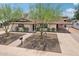 Charming home featuring a well-manicured lawn, mature shade trees, and a welcoming walkway at 7049 E Latham St, Scottsdale, AZ 85257