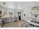 Bright eat-in kitchen featuring wood floors, grey cabinets, and stainless steel appliances at 7049 E Latham St, Scottsdale, AZ 85257