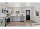 Updated kitchen featuring stainless steel appliances, bright grey cabinets, and light wood floors at 7049 E Latham St, Scottsdale, AZ 85257