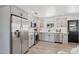 Updated kitchen boasts stainless steel appliances, bright grey cabinets, and light wood floors at 7049 E Latham St, Scottsdale, AZ 85257
