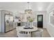 Charming kitchen with stainless steel appliances, grey cabinetry and a modern dining table at 7049 E Latham St, Scottsdale, AZ 85257