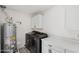 Laundry room with washer, dryer, cabinet storage and decorated floors at 7049 E Latham St, Scottsdale, AZ 85257