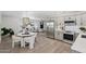 Open-concept living area boasting stainless steel appliances, modern lighting, and seamless flow for entertaining at 7049 E Latham St, Scottsdale, AZ 85257