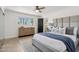 Cozy main bedroom with decorative rug, a ceiling fan, and an en suite bathroom at 7049 E Latham St, Scottsdale, AZ 85257