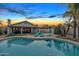 Stunning backyard at sunset with a refreshing pool, lounge chairs, and outdoor seating area at 7140 E Juanita Ave, Mesa, AZ 85209