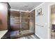 Contemporary bathroom showcasing a glass enclosed shower with stylish brown tile at 7140 E Juanita Ave, Mesa, AZ 85209