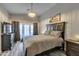 Serene bedroom with hardwood floors, a decorative chandelier, and direct access to the outdoors at 7140 E Juanita Ave, Mesa, AZ 85209