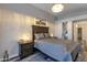 Comfortable bedroom featuring a decorative chandelier and elegant gray color palette at 7140 E Juanita Ave, Mesa, AZ 85209